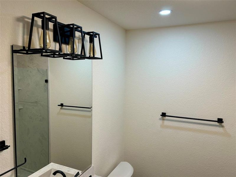 Bathroom with a textured wall and a shower