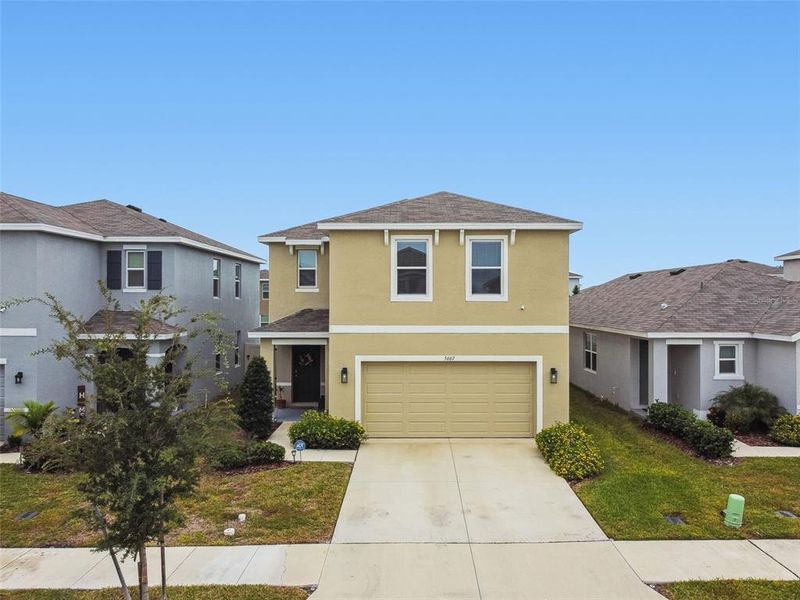 Front exterior of a new home in Westgate at Avalon Park, Wesley Chapel, FL, highlighting curb appeal (Image 25).