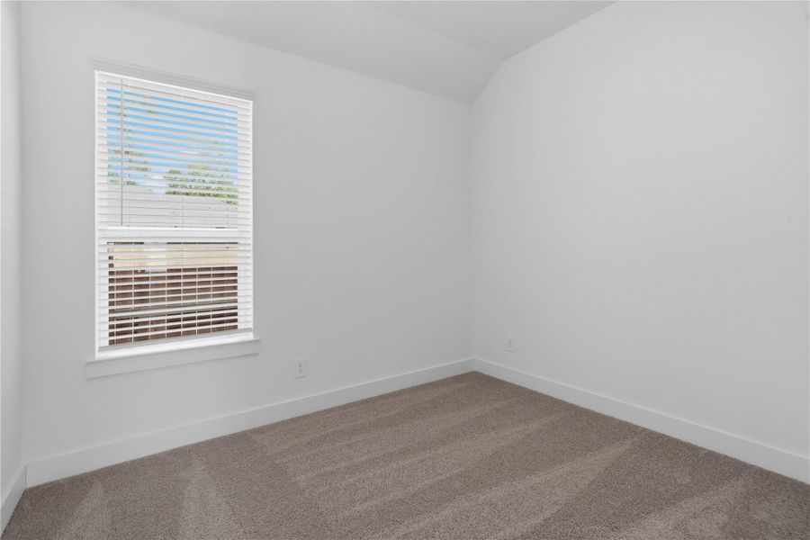 Step into this bright and airy secondary bedroom! It offers a tranquil space to unwind. The large window illuminates the room's sloped ceiling and neutral tones, creating a cheerful and airy environment. This room also features a spacious closet. Step into this bright and airy secondary bedroom! It offers a tranquil space to unwind. The large window illuminates the room's sloped ceiling and neutral tones, creating a cheerful and airy environment. This room also features a spacious closet.