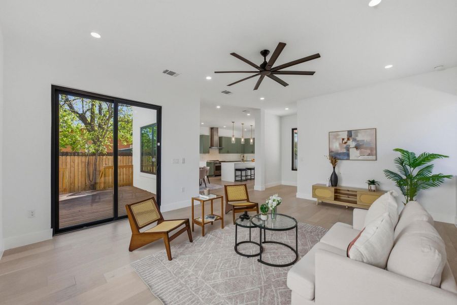 Living room featuring plenty of natural light, light wood finished floors, recessed lighting, and ceiling fan
