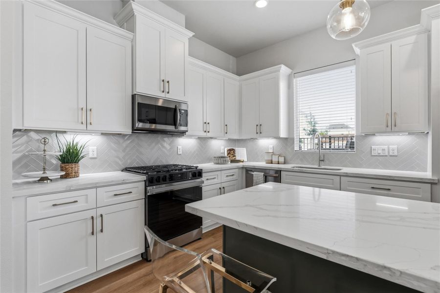 The herringbone backsplash, under mount lighting, and brass accents come together to create a kitchen that feels refined and well designed. The herringbone backsplash, under mount lighting, and brass accents come together to create a kitchen that feels refined and well designed.