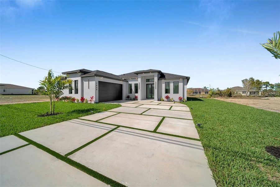 Front exterior of a new home in , Cape Coral, FL, highlighting curb appeal (Image 29). Front exterior of a new home in , Cape Coral, FL, highlighting curb appeal (Image 29).