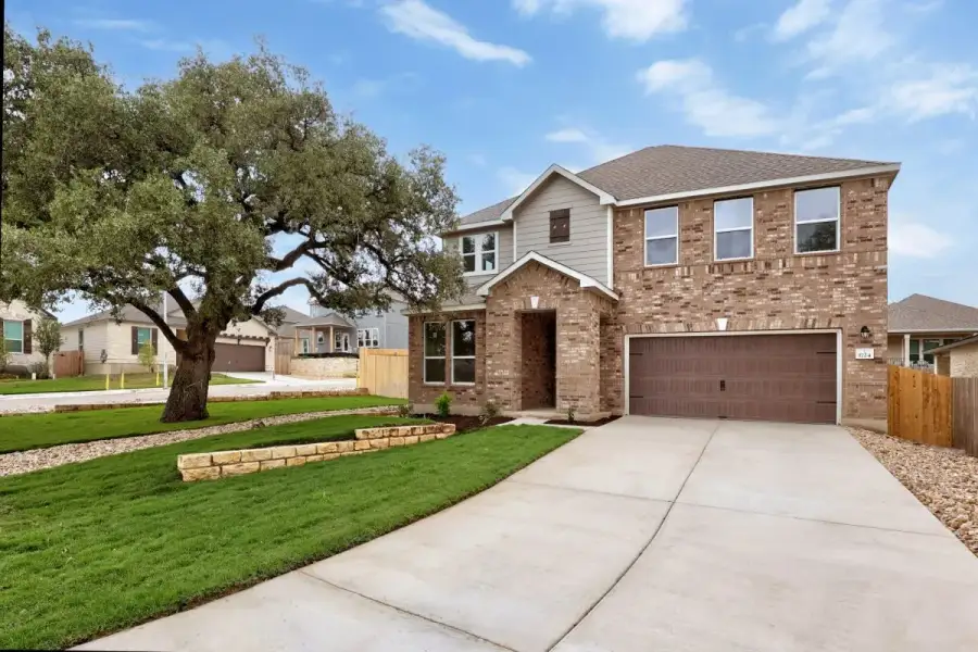 Front exterior of a new home in River Bluff, Leander, TX, highlighting curb appeal (Image 18).