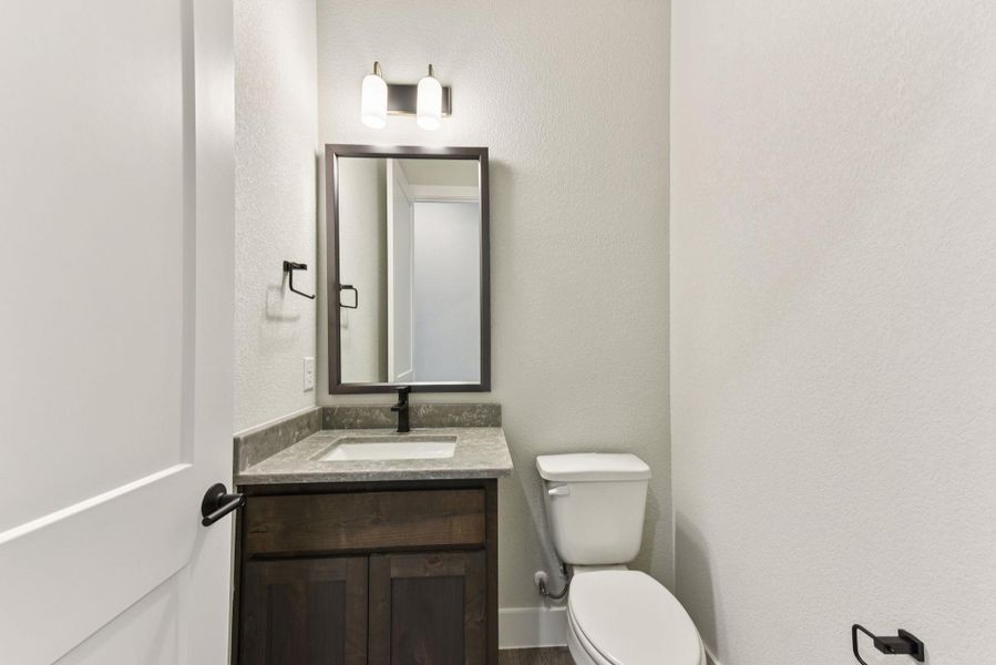 Bathroom with vanity and a textured wall Bathroom with vanity and a textured wall