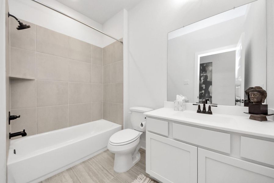 4th full guest bathroom upstairs, featuring a spacious vanity, modern fixtures, and a tub/shower combo.