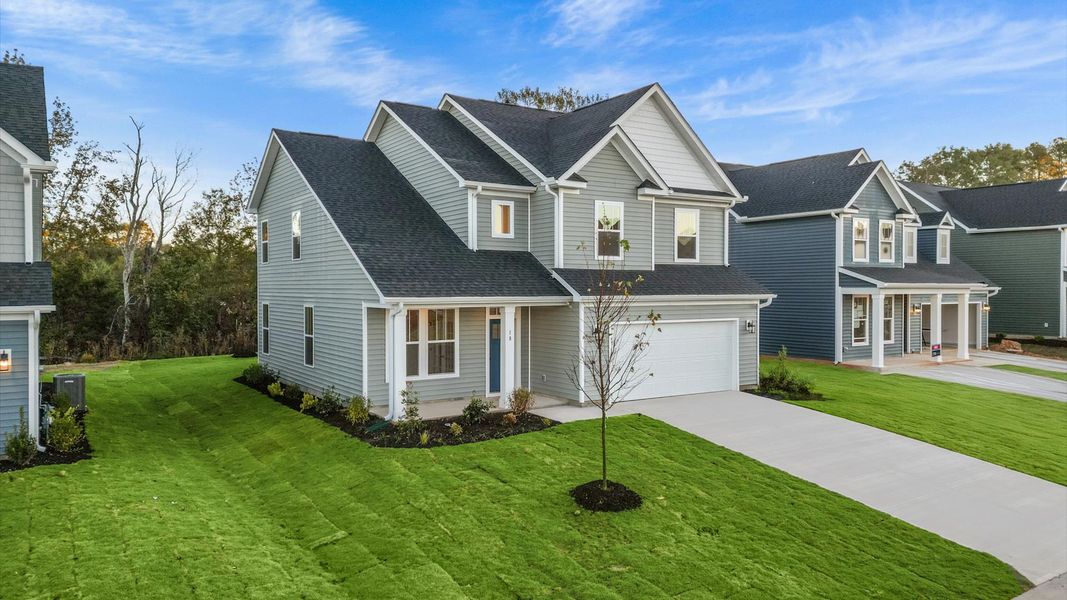 Front exterior of a new home in Woodglen, Piedmont, SC, highlighting curb appeal (Image 2). Front exterior of a new home in Woodglen, Piedmont, SC, highlighting curb appeal (Image 2).