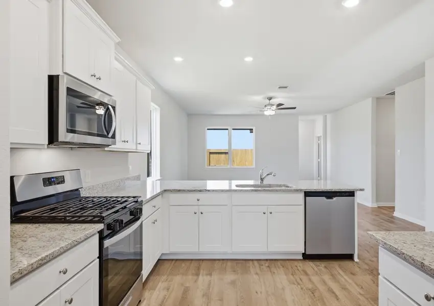 Kitchen with stainless gas range and dishwasher in Montgomery floor plan