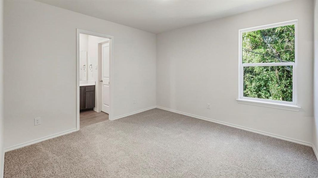 Unfurnished room featuring light colored carpet and baseboards