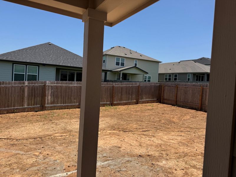 Fenced backyard featuring a residential view Fenced backyard featuring a residential view