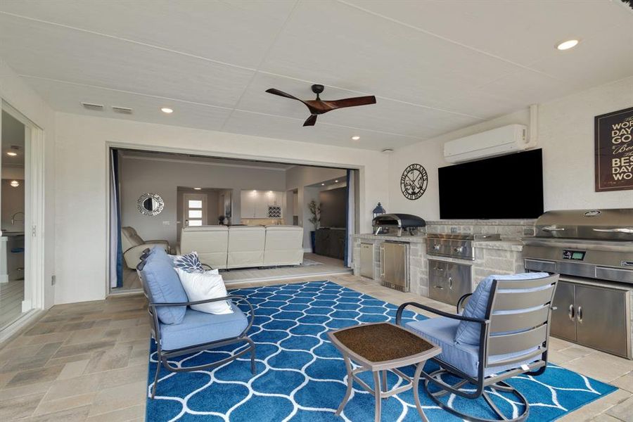 The back patio offers you stackable patio doors, an outdoor kitchen, a mini-split that provides both heat and A/C, motorized screens, and so much more!