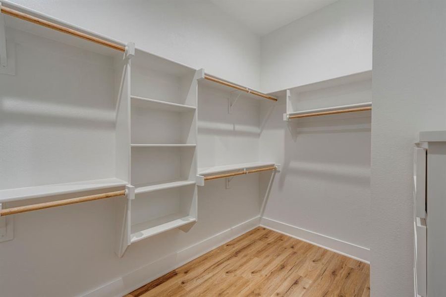 Walk in closet featuring wood-type flooring