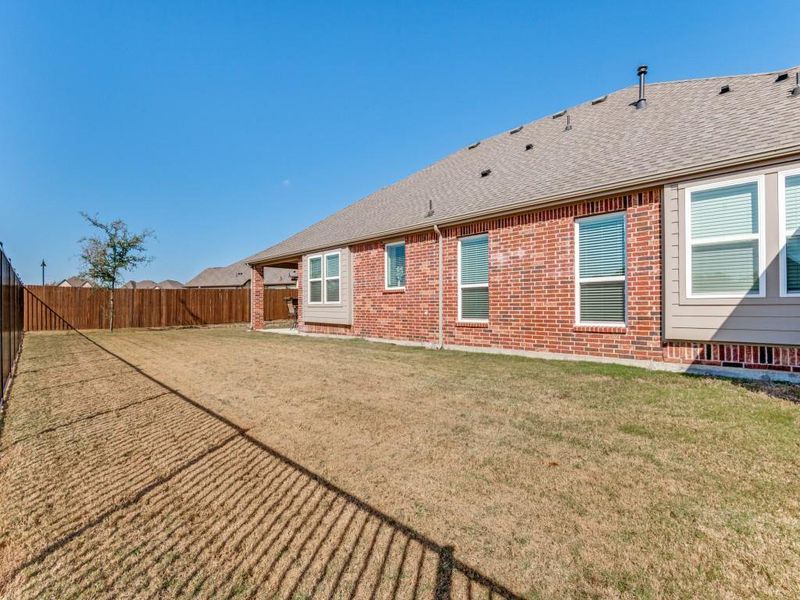 Exterior details and patio area of a home in Oaks of North Grove, Waxahachie (Image 4).