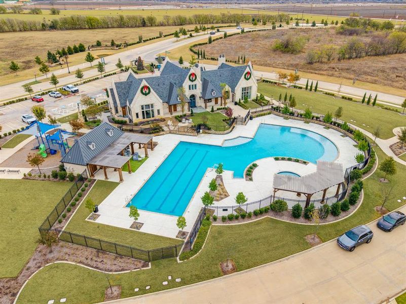 Aerial view of property and surrounding area featuring a pool