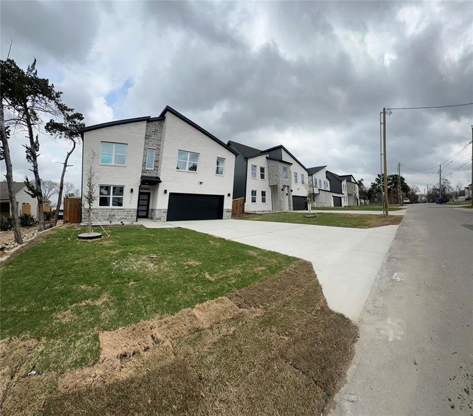 Front exterior of a new home in , Dallas, TX, highlighting curb appeal (Image 14).