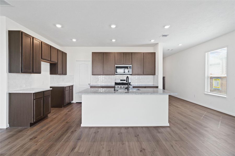 This spacious kitchen has it all—ample storage, generous counter space, and a layout that truly makes it the heart of the home. This spacious kitchen has it all—ample storage, generous counter space, and a layout that truly makes it the heart of the home.