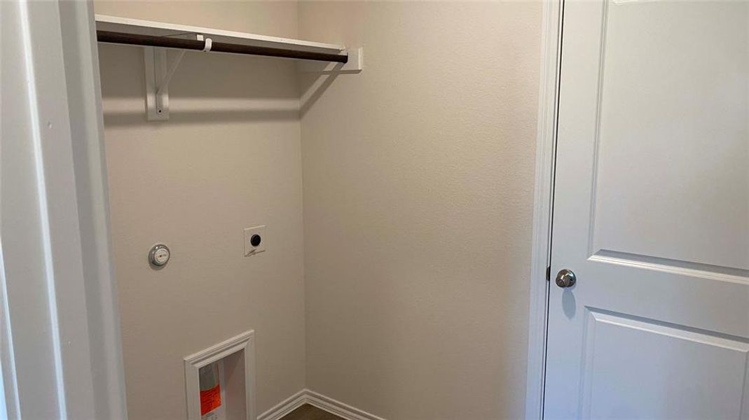 Laundry area featuring hookup for an electric dryer and baseboards