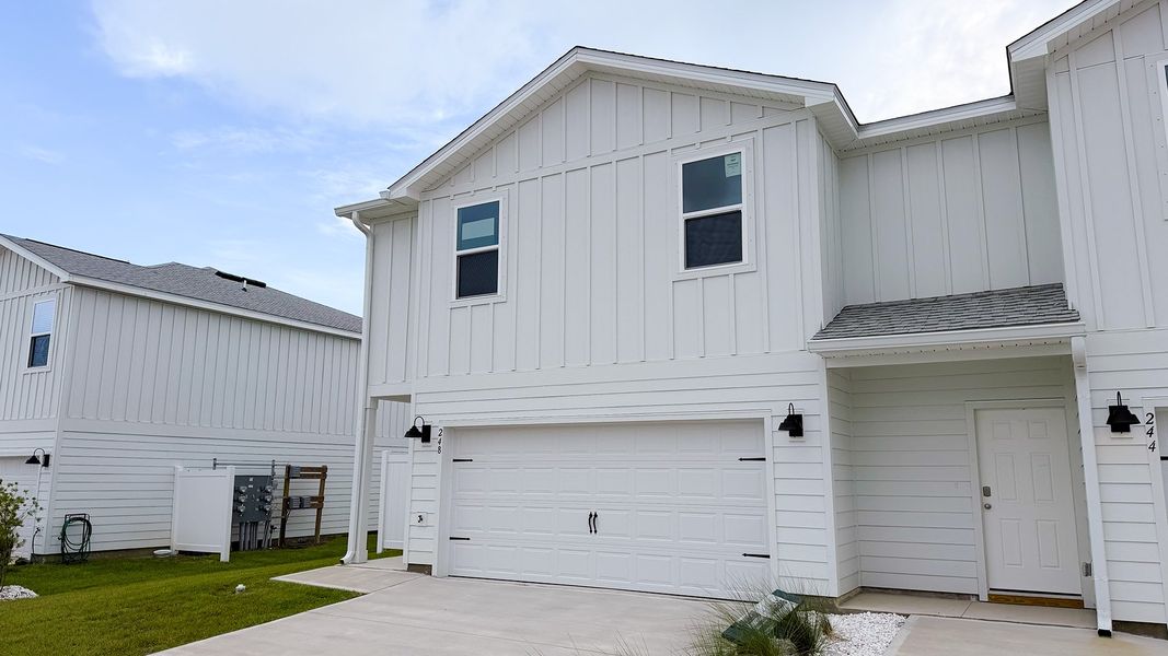 Front exterior of a new home in Salt Creek Townhomes at Mexico Beach, Mexico Beach, FL, highlighting curb appeal (Image 16). Front exterior of a new home in Salt Creek Townhomes at Mexico Beach, Mexico Beach, FL, highlighting curb appeal (Image 16).