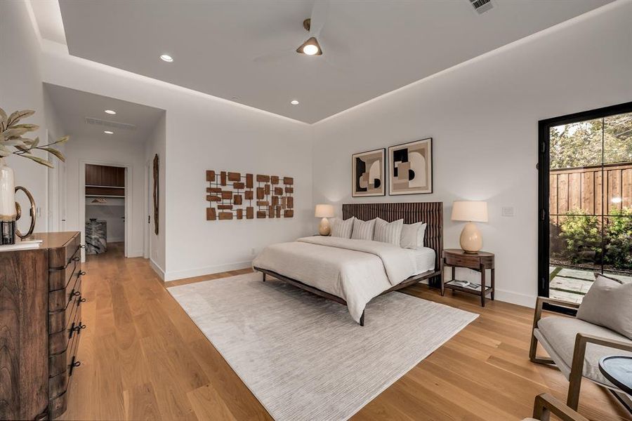 Bedroom featuring light wood-type flooring, recessed lighting, access to exterior, and ceiling fan Bedroom featuring light wood-type flooring, recessed lighting, access to exterior, and ceiling fan