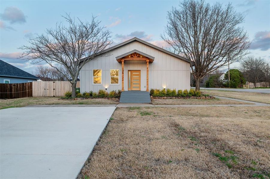 View of front of home featuring fence