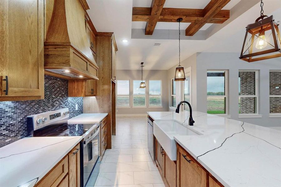 Kitchen with a wealth of natural light, tasteful backsplash, hanging light fixtures, and stainless steel appliances