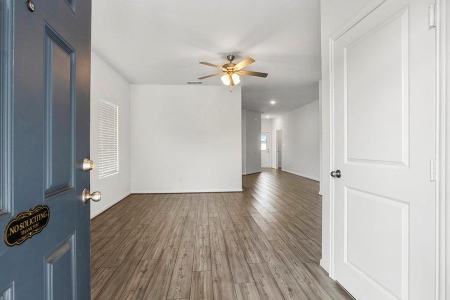 Unfurnished room with wood finished floors and a ceiling fan