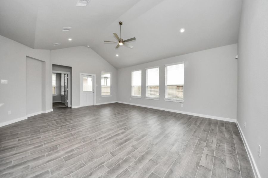 Gather the family and guests together in your lovely living room! Featuring soaring highceilings, recessed lighting, ceiling fan, custom paint, gorgeous floors, and large windows thatprovide plenty of natural lighting throughout the day.