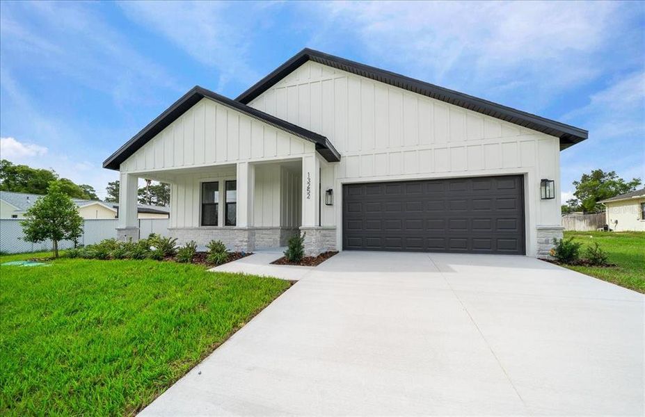 Front exterior of a new home in , Spring Hill, FL, highlighting curb appeal (Image 26).