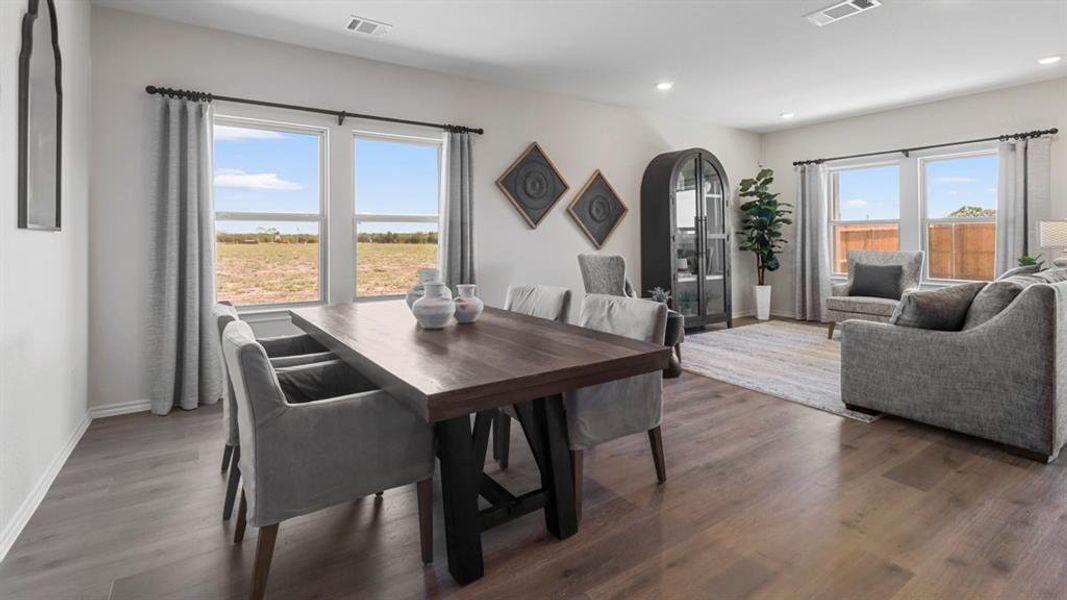 Dining area featuring dark wood-style flooring and recessed lighting