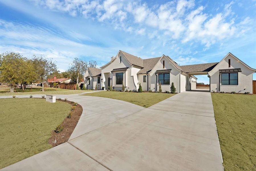 View of front of house with concrete driveway, stucco siding, and roof with shingles