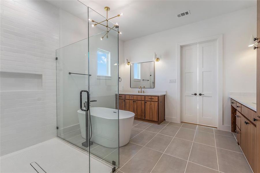 Glass-enclosed shower featuring white subway tile, a built-in niche, and a linear drain Glass-enclosed shower featuring white subway tile, a built-in niche, and a linear drain