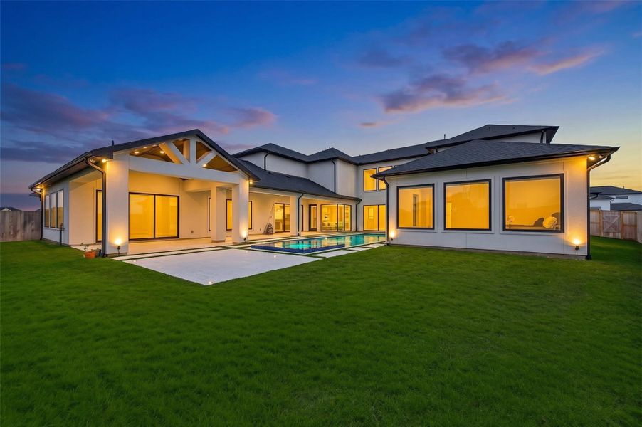 The massive backyard offers endless possibilities for entertaining and recreation with abundant space for a putting green, playset, or custom outdoor amenities, along with additional side yard space for even greater flexibility.