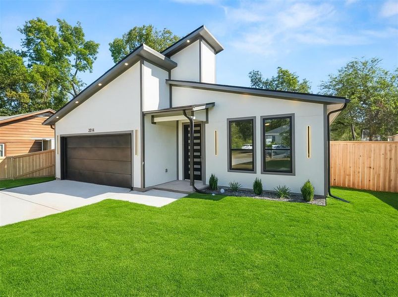 Contemporary home with stucco siding, concrete driveway, and a garage