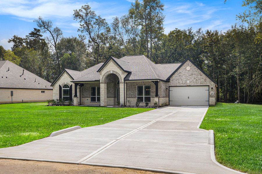 Front exterior of a new home in Encino Estates, Dayton, TX, highlighting curb appeal (Image 18).