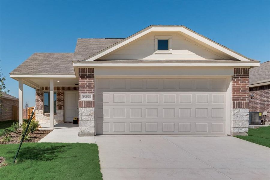 Ranch-style home with cooling unit, a garage, and a front yard