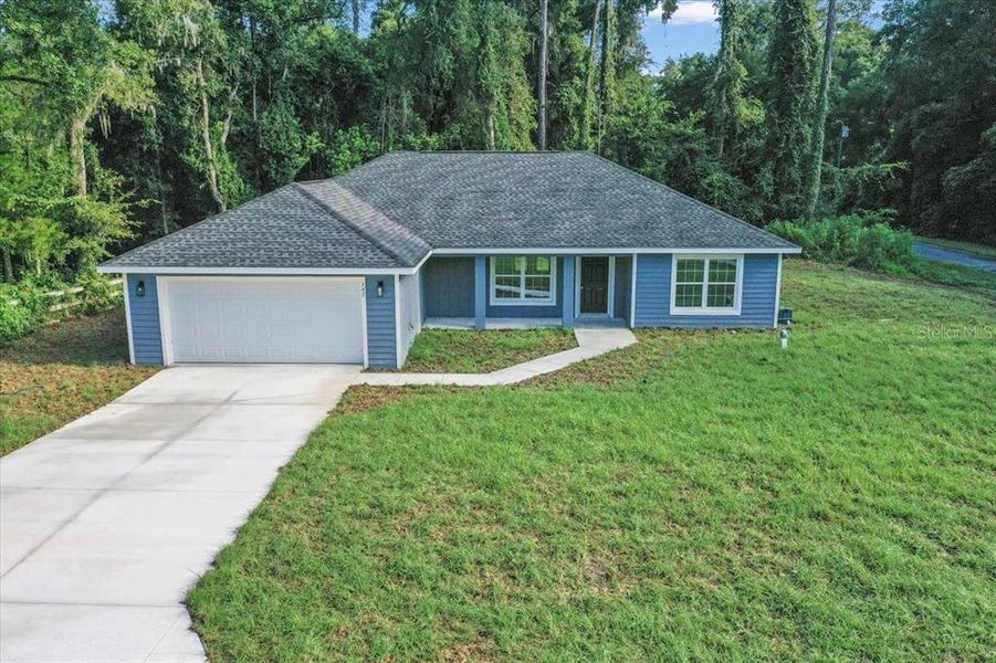 Front exterior of a new home in , Dunnellon, FL, highlighting curb appeal (Image 1).
