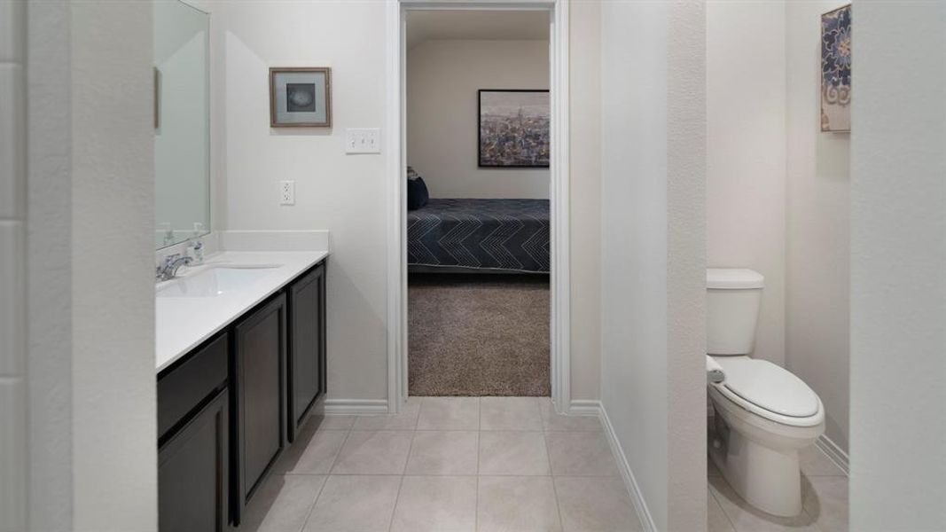 Full bathroom with vanity, connected bathroom, and light tile patterned flooring