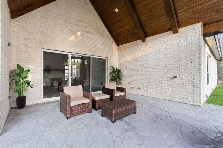 The expansive covered patio is an entertainer’s dream, featuring a second stone chimney