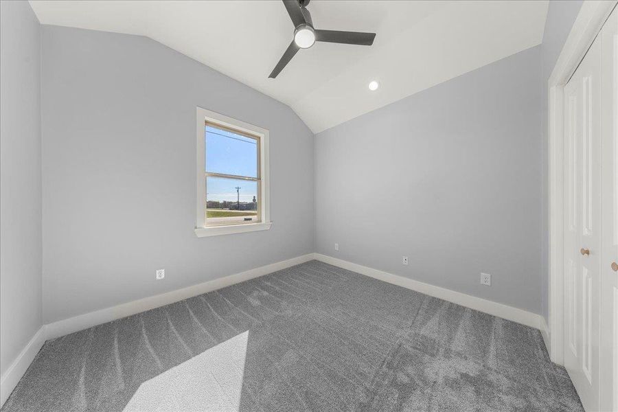 Unfurnished bedroom featuring a closet, vaulted ceiling, a ceiling fan, carpet flooring, and recessed lighting Unfurnished bedroom featuring a closet, vaulted ceiling, a ceiling fan, carpet flooring, and recessed lighting