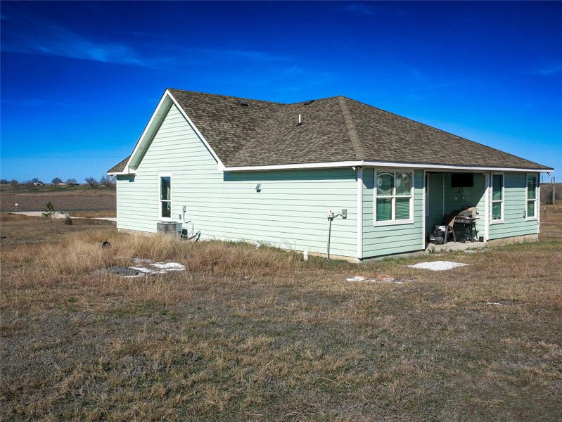 View of side of home featuring a shingled roof