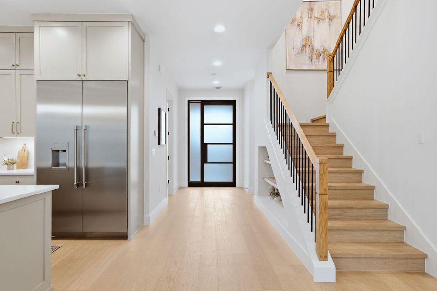 Entrance foyer with light wood finished floors and recessed lighting