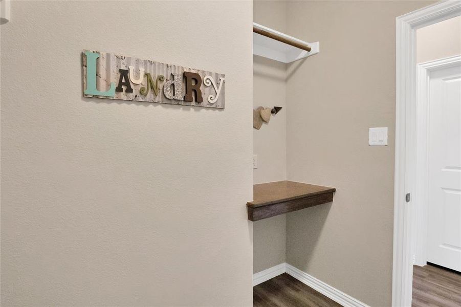 Spacious laundry room with hanging space and folding table!