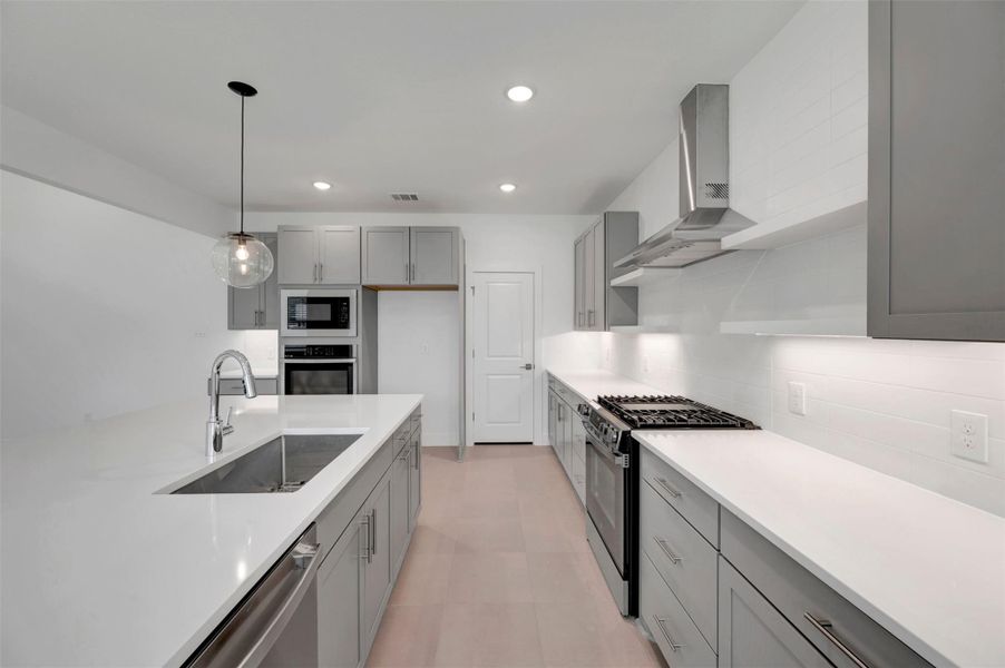 Stylish kitchen with grey cabinets and decorative floating shelves Stylish kitchen with grey cabinets and decorative floating shelves