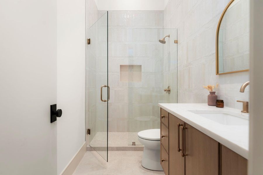 Bathroom featuring vanity and a shower stall