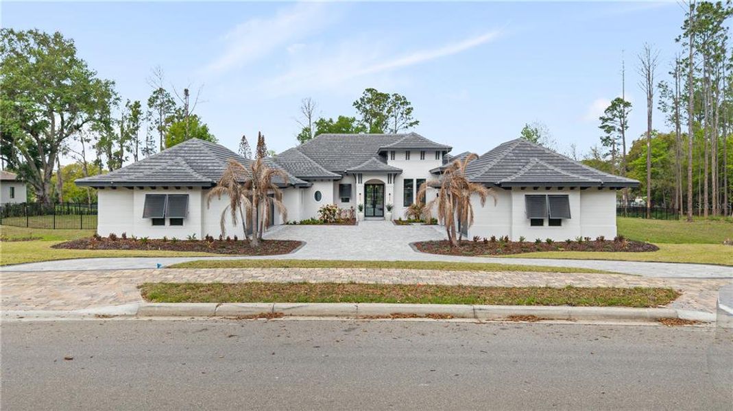Front exterior of a new home in Bella Collina, Montverde, FL, highlighting curb appeal (Image 22). Front exterior of a new home in Bella Collina, Montverde, FL, highlighting curb appeal (Image 22).