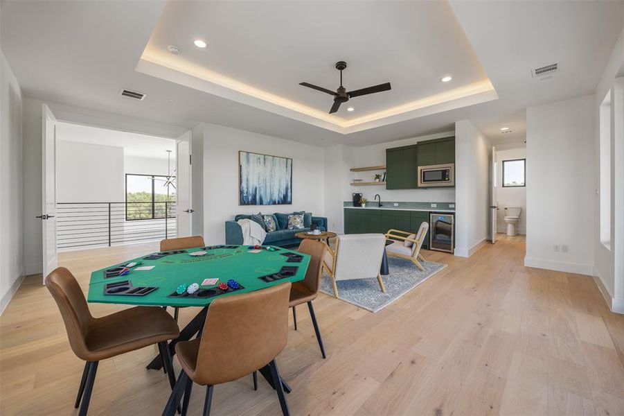 A vibrant game room with a wet bar offers ample space for entertainment and relaxation.
