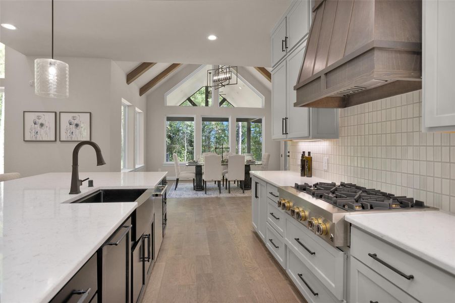 Vaulted ceilings with exposedbeams frame the elegant diningarea, perfectly positioned justbeyond the gourmet kitchen foreffortless entertaining.