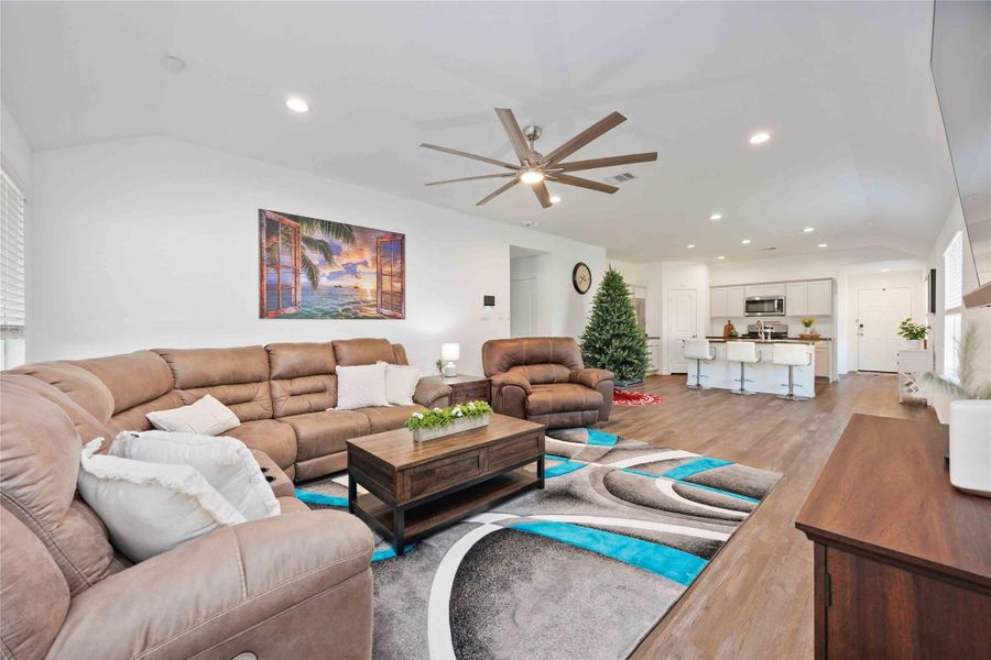 Open Living Area – Wide ViewExpansive open living space showcasing high ceilings, recessed lighting, and a modern ceiling fan, with a seamless connection to the kitchen and dining areas. The generous layout easily accommodates multiple seating arrangements, making it ideal for entertaining, relaxing, or everyday living in a bright, cohesive environment. Open Living Area – Wide ViewExpansive open living space showcasing high ceilings, recessed lighting, and a modern ceiling fan, with a seamless connection to the kitchen and dining areas. The generous layout easily accommodates multiple seating arrangements, making it ideal for entertaining, relaxing, or everyday living in a bright, cohesive environment.