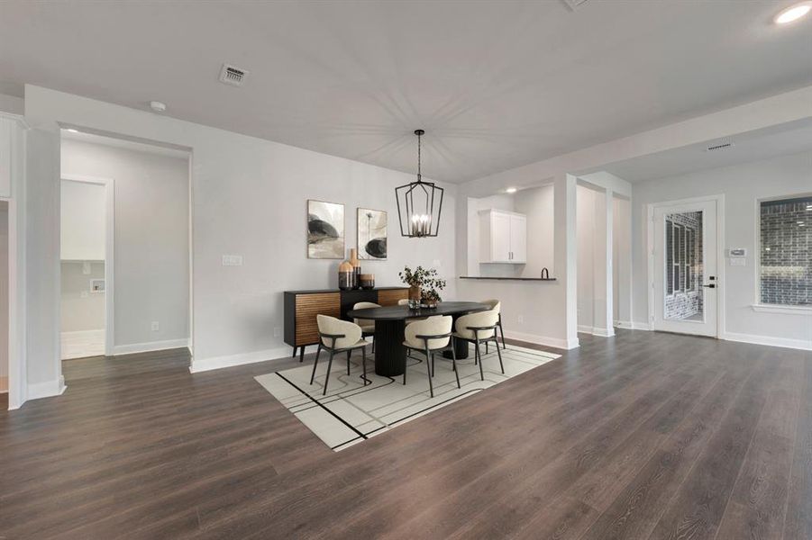 Dining space with dark wood-type flooring and hanging lights