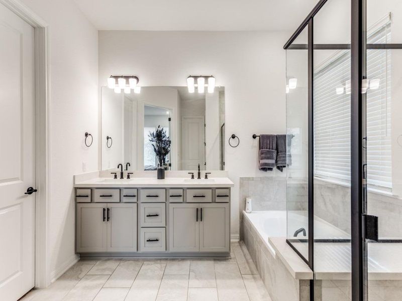 Other features include dual sinks with quartz counters and modern black matte finishes.