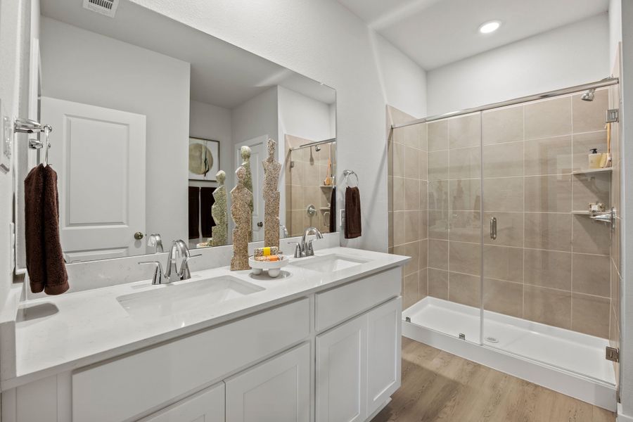 A bathroom with a glass shower. A bathroom with a glass shower.